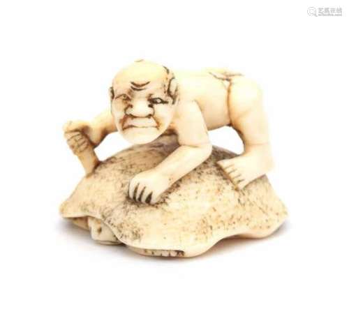 A Japanese ivory netsuke, a man with a dagger on the back of a turtle. Meiji period (1868-1912).3