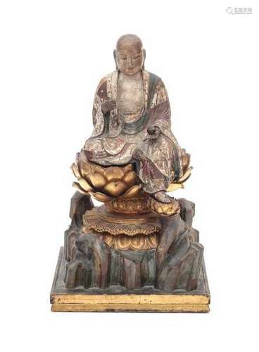 A Japanese finely carved lacquer figure of Jizo Bosatsu, seated on a gilt lotus throne, on a rocky