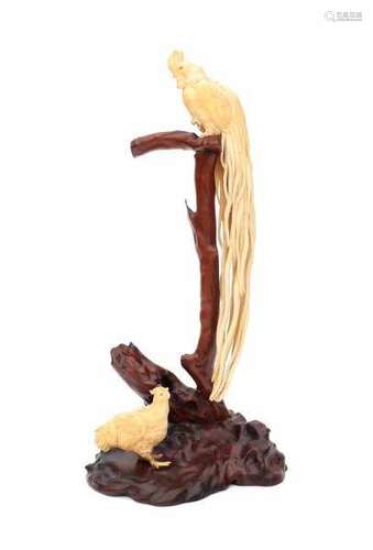 A Japanese carved ivory group on a naturalistic carved base. The cockerel perched on a branch with