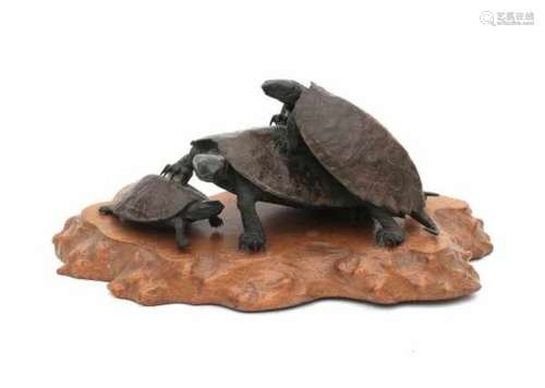 A Japanese bronze okimono in the manner of Rokusai. Three clambering tortoises. Signed on belly.