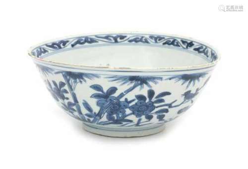 A Chinese blue and white bowl, decorated with a bird on a rock between blossoming flowers. With