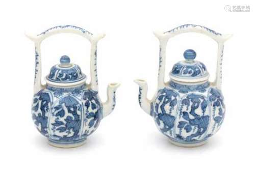 A pair of small Chinese blue and white wine pots, decorated with vines in panels. Kangxi period (