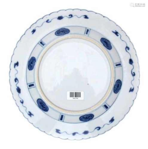 A Chinese blue and white plate, decorated with an elegant lady and a playing boy in a garden,