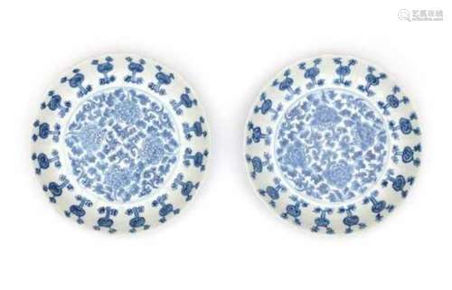 A pair of Chinese blue and white plates, decorated with peonies. Marked with an apocryphal