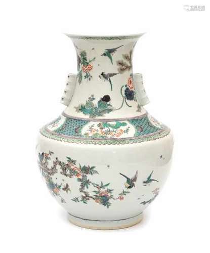 A large Chinese famille verte vase, decorated with birds and insects in a garden scene with