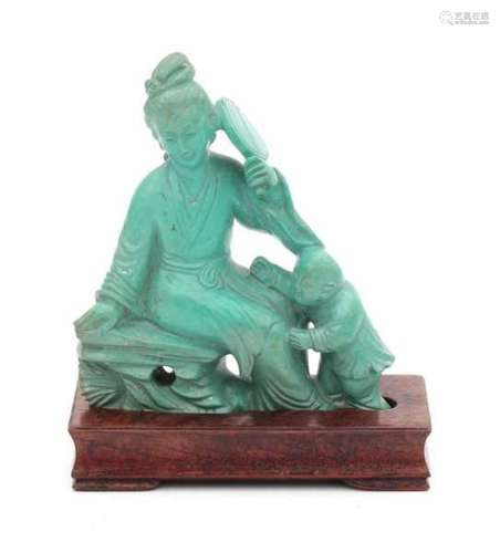 A carved turquoise sculpture, sitting lady with fan. With wooden stand. In box. 20th century.