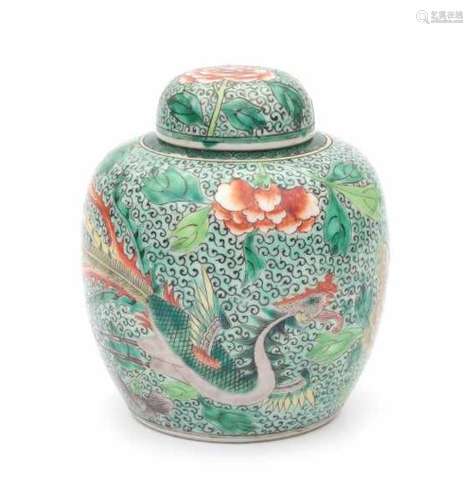 A Chinese famille verte lidded jar, decorated with a phoenix amidst flowering peonies. 19th