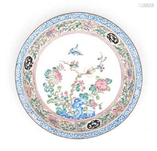 A Canton enamel dish, decorated with a swallow and an insect amidst flowering plants. 19th