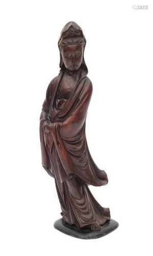 A Chinese carved wooden sculpture, Guanyin dressed in loose robes. 19th centuryheight 34 cm.- - -