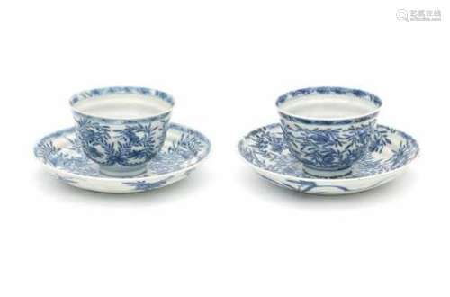 A pair of Chinese blue and white horizontally ribbed cup and saucers, decorated with lotus. With