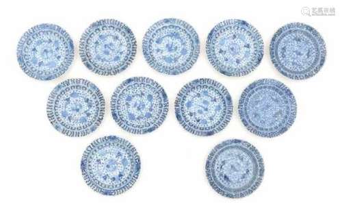 A set of eleven Chinese blue and white saucers, decorated with carp and sturgeon. With four