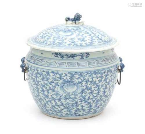 A Chinese blue and white lidded jar, with a scrolling floral pattern. The cover with a foo dog