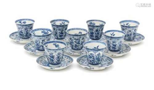 A set of nine Chinese blue and white high cup and saucers, decorated with peonies and lotus in petal