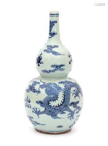 A Chinese blue and white double gourd vase, decorated with dragons and flaming pearl. 19/20th