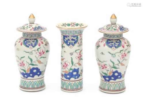 A Chinese famille rose three piece garniture, decorated with lotus. Yongzheng period (1723-1735).