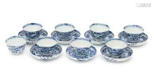 A set of seven Chinese blue and white cup and saucers, decorated with flowers and landscapes in