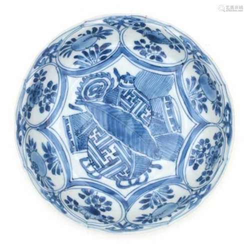 A Chinese blue and white transitional dish, decorated with buddhist symbols surrounded by flowers.