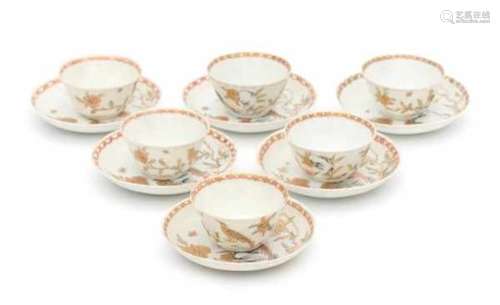 A set of five Chinese export cup and saucers, decorated in gold with a peacock amongst flowering