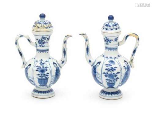 A pair of Chinese blue and white ewers, decorated with long Eliza and flowers in panels. Kangxi