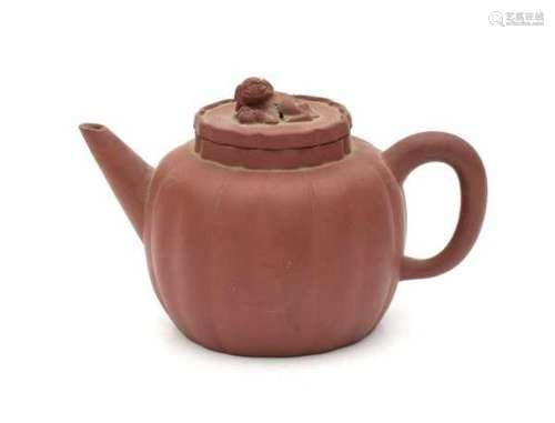 A Yixing lobbed teapot, the lid with a modelled foo dog. Marked with 'Yixing purple clay' mark and a