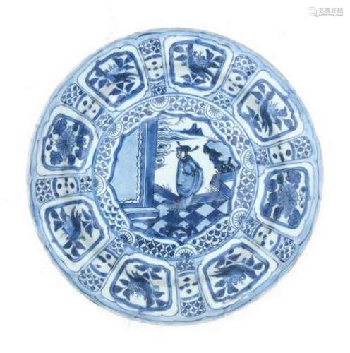 A Chinese blue and white charger, decorated with a dignitary on a chequered floor, surrounded by