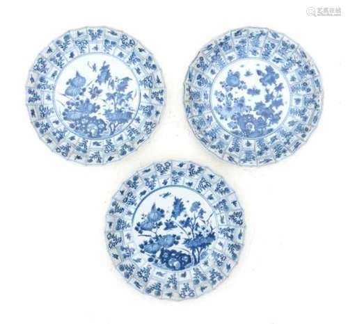 A set of three Chinese blue and white modelled plates, decorated with flowers and insects in a rocky