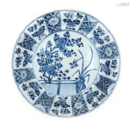 A Chinese blue and white charger, decorated with birds amidst blossom. With artemesia leaf symbol