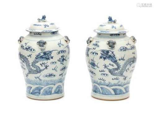 A pair of Chinese blue and white lidded vases, decorated with dragons and flaming pearl of wisdom.