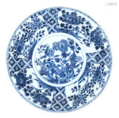 A Chinese blue and white charger, decorated with lotus and peonies in a rocky garden. With symbol