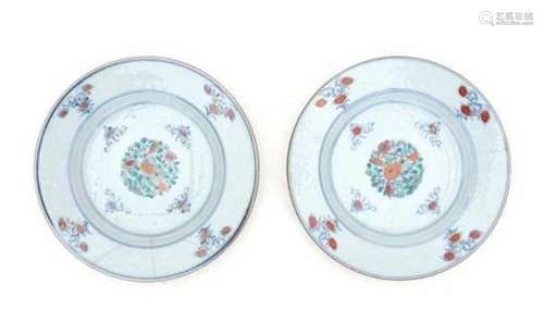 A pair of Chinese famille verte plates, with an incised lotus pattern, a tile shaped central