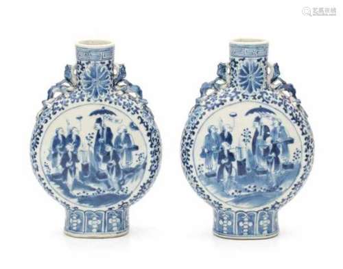 A pair of Chinese blue and white moonflasks, decorated on both sides with a group of street vendors.