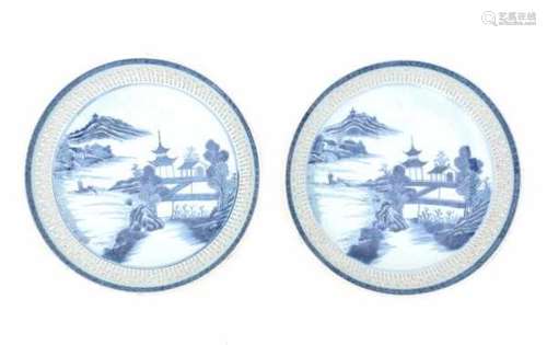 A pair of Chinese blue and white export pierced dishes, decorated with pagodas in a river landscape.