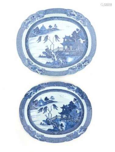 Two Chinese blue and white export serving dishes, decorated with pagodas in a river landscape.