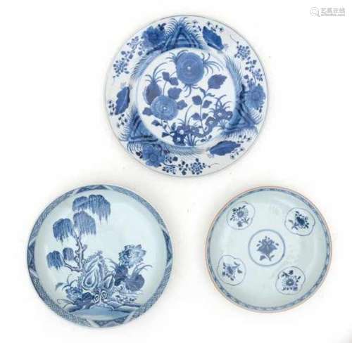 A collection of three Chinese blue and white plates, respectively decorated with; an incised pattern