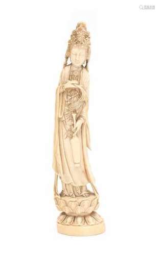 A Chinese ivory sculpture, Guanyin. Dressed in loose robes wearing a crown and holding a bottle