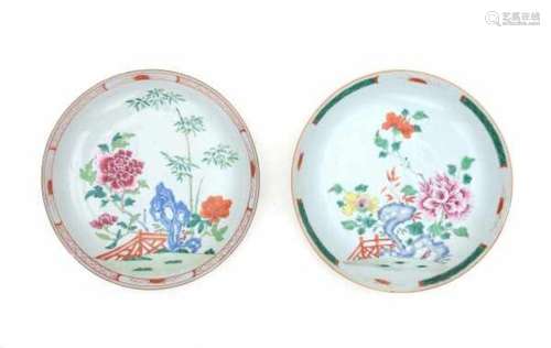 Two Chinese famille rose plates, decorated with bamboo and peonies in a garden. Qianlong period (