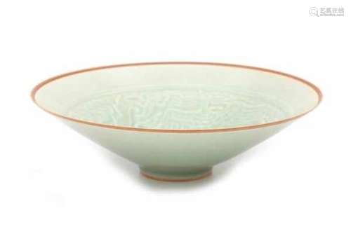 A modelled Chinese celadon bowl, decorated with dragon and phoenix. 20th centuryDiameter 20