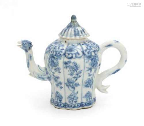 A Chinese blue and white lobbed teapot, decorated with lotus and peonies in panels. The spout in the