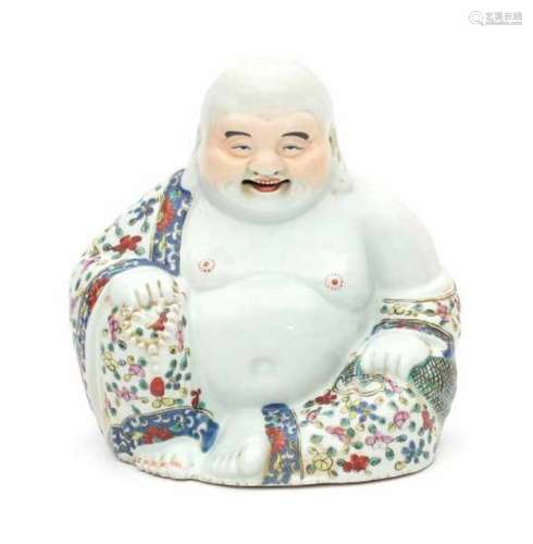 A Chinese famille rose budai holding prayer beads in one hand and a bag in the other. On wooden