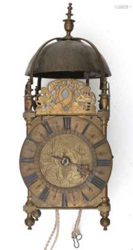 A brass provincial lantern clock. The dial with roman numerals. The clock with one hand and chime.