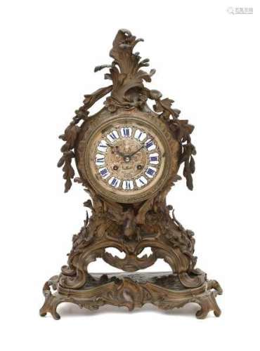 A bronze mantle clock, richly decorated and with a protruding dragon. Rococo style, 19th century.