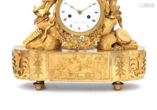An ormulu mantle clock with a figure of Bacchus. The enamelled dial with roman numerals and adress
