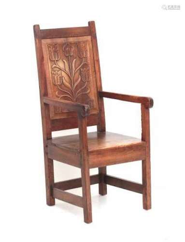 A Dutch elm armchair, the back panel decorated with carved tulips. 18th century.height 115 cm.- - -