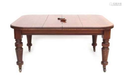 An English mahogany extending table on brass wheels with two extra leaves. 19th century.77 x