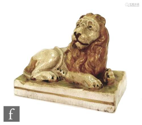 An early 19th Century Wood and Caldwell pearlware model of a recumbent lion glazed in light brown