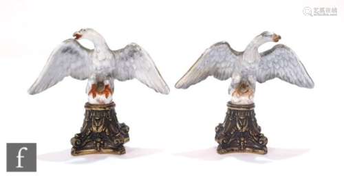 A pair of 19th Century continental porcelain figures modelled as stylised eagles with outstretched