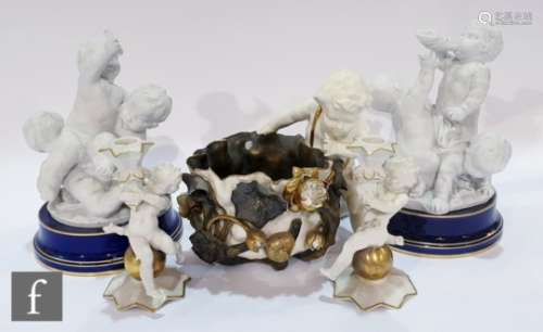 A 19th Century Moore & Co figural bowl modelled as a putti with a basket decorated with branches,