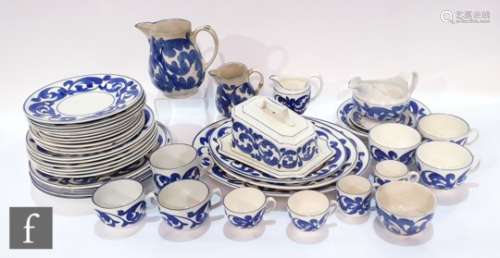 An early 20th Century part dinner service hand decorated in under glaze blue with a simple scroll