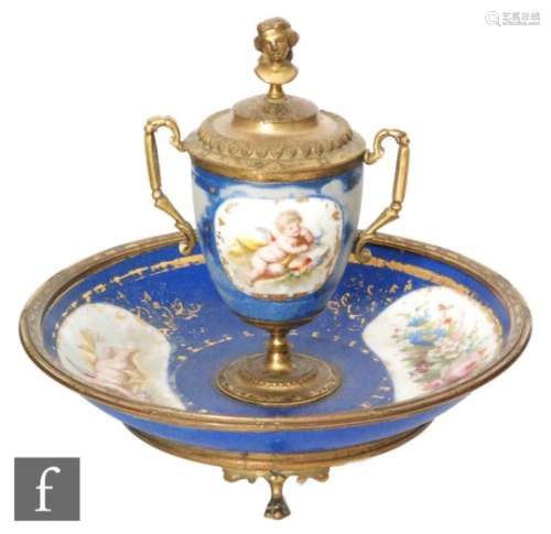 A late 19th Century Sevres style inkwell of urn form with metal mounts with female bust finial and