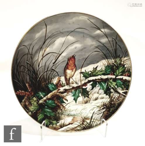 An English porcelain wall charger of circular form, the central well painted with a winter scene